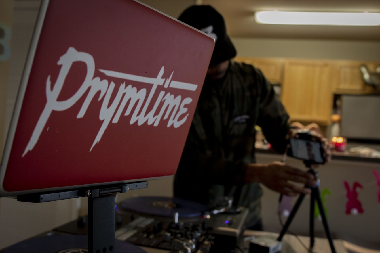 DJ Prymetime sets up equipment for his virtual party.